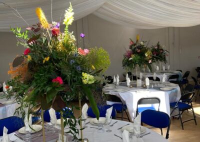 Wedding reception tables with flowers at The Coddenham Centre Near Ipswich Suffolk