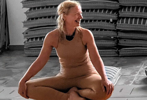 Yoga with Jo sitting on mat crossed legged